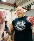 Brock Lesnar Holding Brock Lesnar Bearded Butcher Blend Seasoning Shaker and Tomahawk Steak