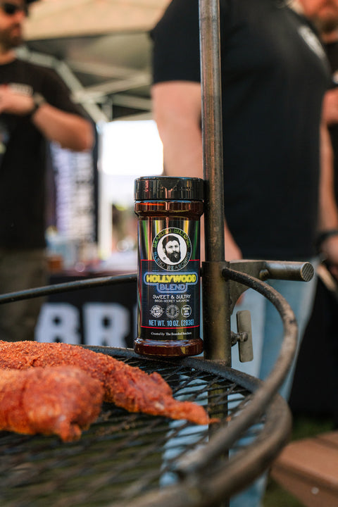 Bottle of Hollywood Blend on a grill with people in the background