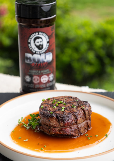 Steak on a plate with a jar of seasoning in the background
