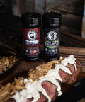Two bottles of 'Butcher' seasoning on a wooden cutting board with cooked meat and onions.