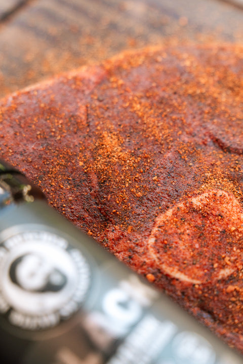 Marinaded beef on a cutting board with a knife