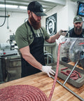 The Bearded Butchers making sausage