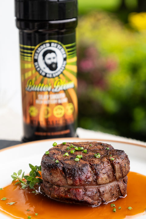 Steak on a plate with a bottle of seasoning in the background