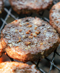 Close-up of grilled meat patties on a grill