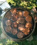 Hamburgers cooking on a grill with a grassy background
