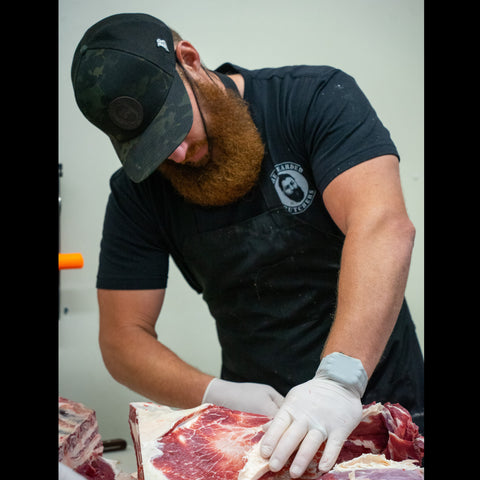 The Bearded Butchers butchering wearing a Black Bearded Butcher T shirt
