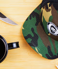 Bearded Butcher Snap-Back Hat and Mug on Table