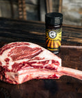 Butter Bearded Butcher Blend Seasoning by Tomahawk Steak on Cutting Board
