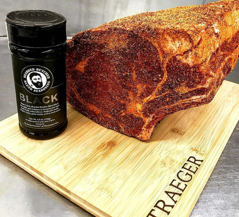 Bearded Butcher Blend Seasoning Black Shaker and Meat on Cutting Board